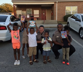 Sheriff Giving Books to Macon Children